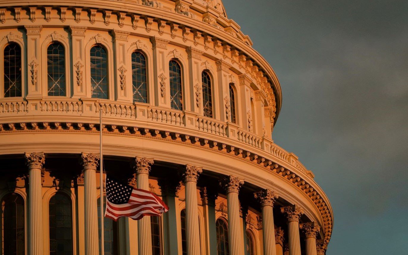 Close-up-of-capitol-building-at-dawn-with-US-flag-1.jpg