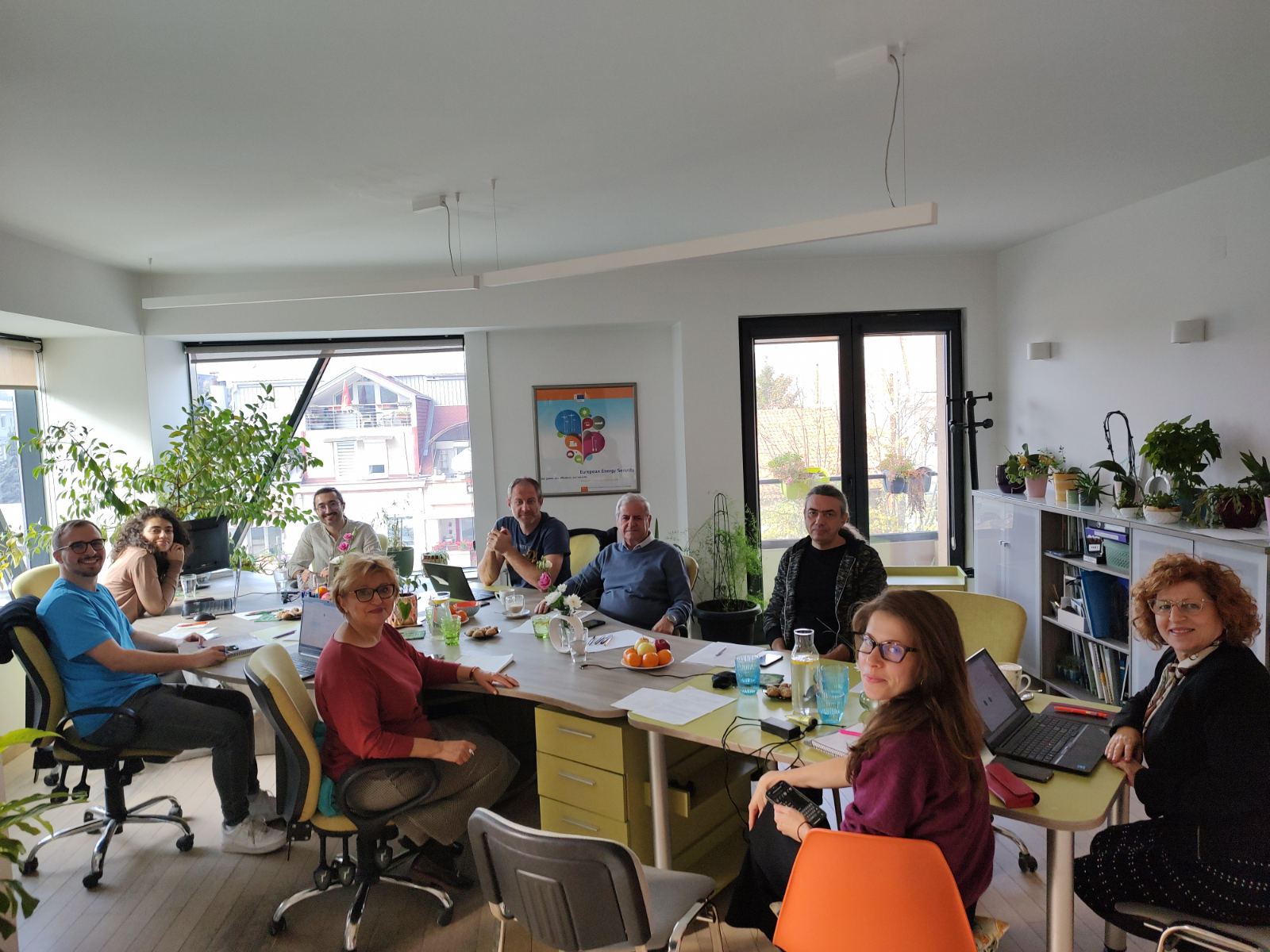A group of people sitting around a table
AI-generated content may be incorrect.