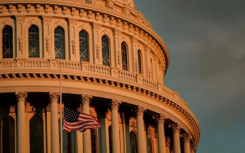 Close-up-of-capitol-building-at-dawn-with-US-flag-1.jpg