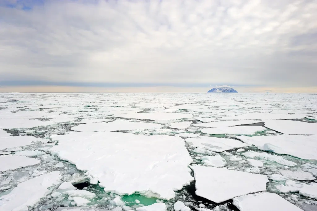 Small-island-in-the-Ross-Sea-Antarctica-with-pack-ice-in-the-foreground_E7RH8P.jpg