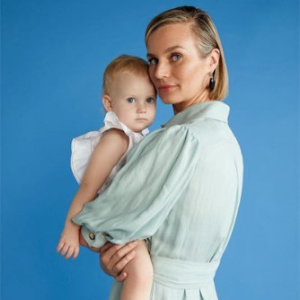 Erin Remblance holding her daughter, aged one